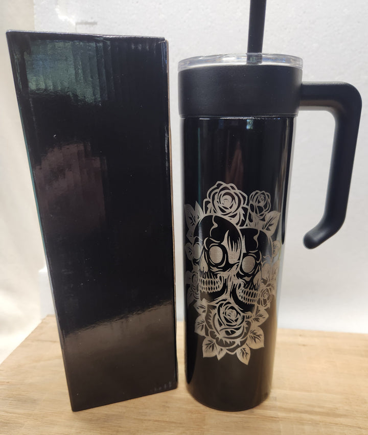 Bold. Intricate. Timeless. This 20oz black tumbler features a laser-engraved design of stylized skulls framed by blooming roses—an LDJ tribute to strength, memory, and the beauty found in contrast. Packaged in a matching black gift box, it’s built for those who carry legacy in every sip.
• 	20oz insulated tumbler with handle, lid, and straw
• 	Laser-engraved skull and rose design
• 	Includes matte black gift box for premium presentation
• 	Hand wash recommended to preserve engraving
• 	Designed and packaged